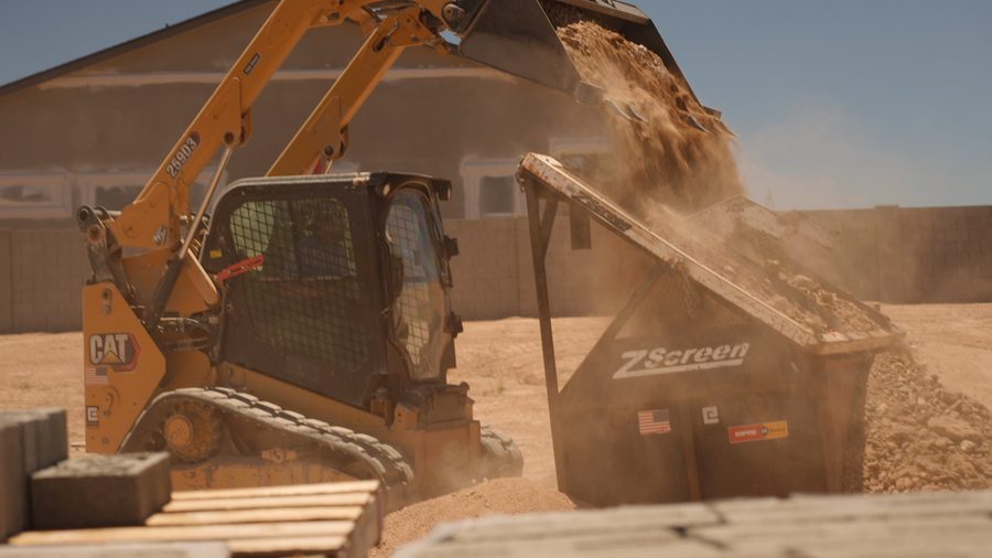 CAT skid steer loading material into a screening plant on a Yavapai County job site